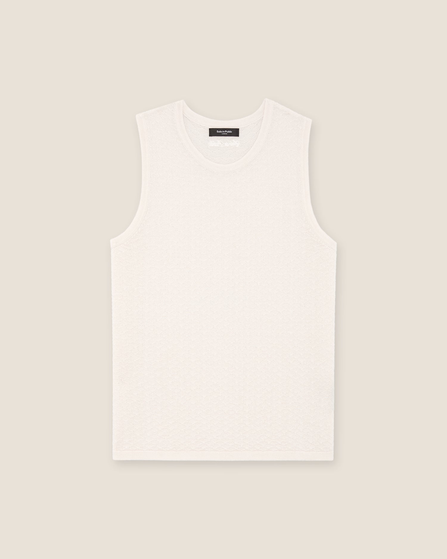 Flat lay of 100% merino wool tank top made in Italy with textured knit construction — luxury contemporary menswear knitwear piece.