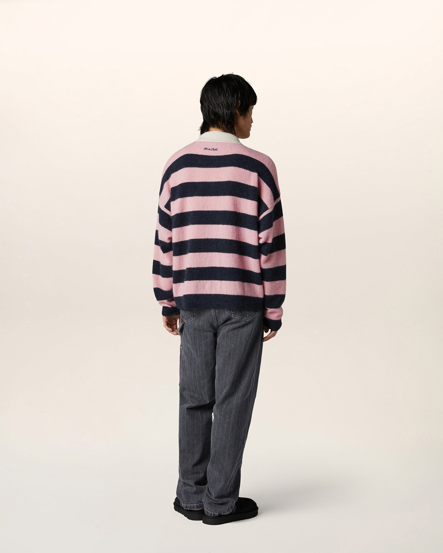 Person wearing striped alpaca knit rugby top with relaxed fit and contrast collar — luxury streetwear knitwear for men.