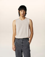 Close-up of textured merino wool sleeveless vest with relaxed fit — contemporary luxury menswear knitwear detail.