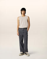 Model wearing textured merino wool sleeveless vest with relaxed pinstripe carpenter jeans — contemporary luxury menswear outfit.
